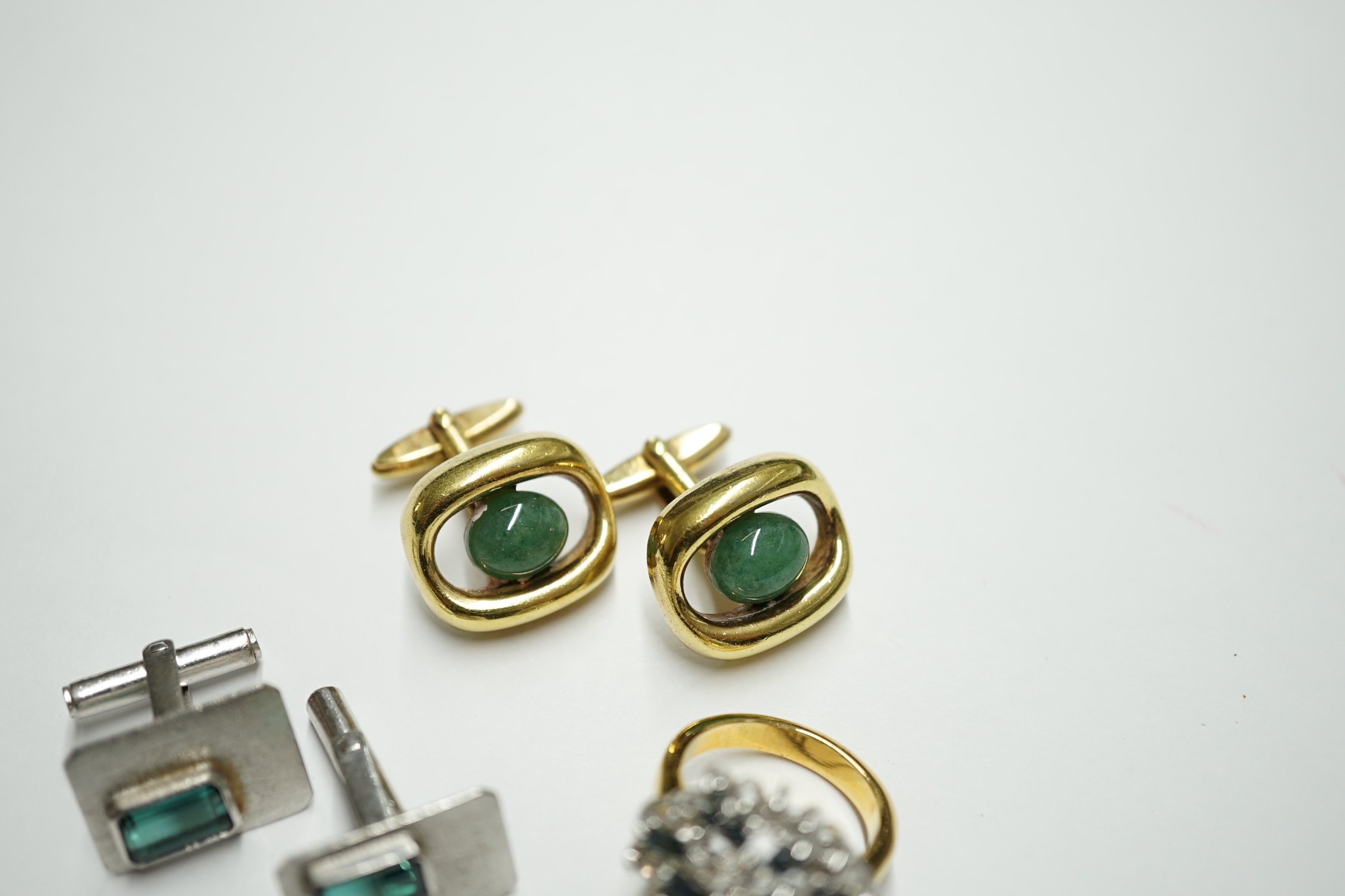 A pair of Lanvin gold plated cufflinks, each set with an oval green cabochon, a pair of silvered metal cufflinks set green stones and a costume ring. Condition - fair